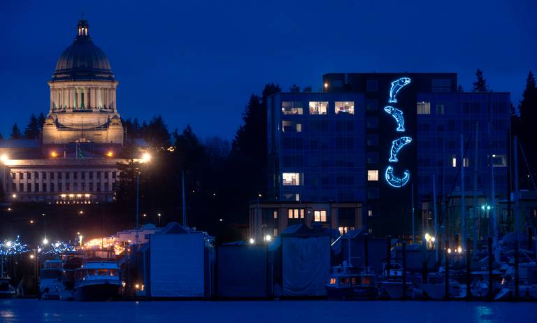 Olympias capital building at night with view of salmon lit up