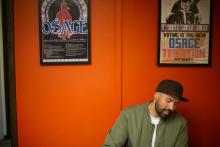 Ben Brockie in front of Osage Nation posters