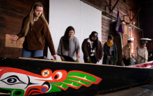 Student members of the canoe family participate in the cleansing of the canoe during the Canoe Awakening in April 2023. Photo by Mark Stone.