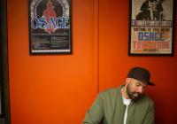 Ben Brockie in front of Osage Nation posters