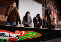 Student members of the canoe family participate in the cleansing of the canoe during the Canoe Awakening in April 2023. Photo by Mark Stone.