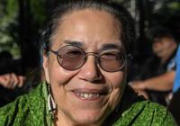 Dian Million wearing glasses, smiling at the camera.