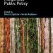 Book cover for Handbook of Indigenous Public Policy, edited by Sheryl Lightfoot and Sarah Maddison. The cover features vertical bands of woven natural materials in earthy tones—greens, browns, and tans—set against a dark background, with the publisher Edward Elgar listed at the top.